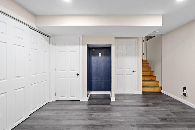 entryway with baseboards, dark wood-style flooring, and stairway