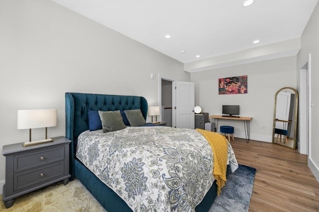 bedroom featuring light wood finished floors, recessed lighting, and baseboards