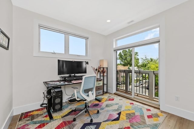 office space featuring baseboards and wood finished floors