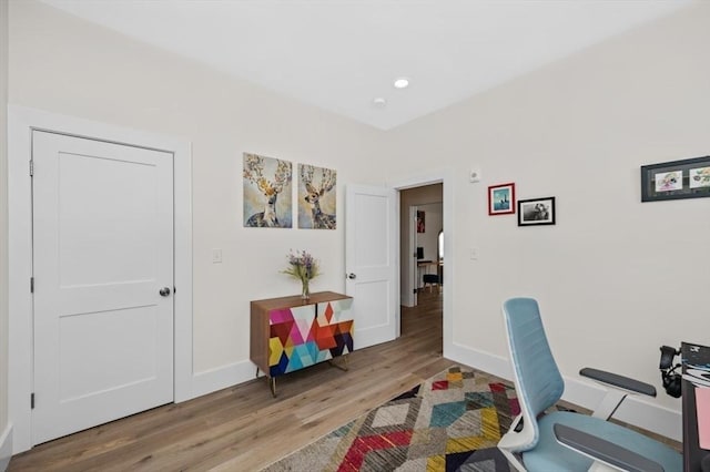office featuring wood finished floors, baseboards, and recessed lighting