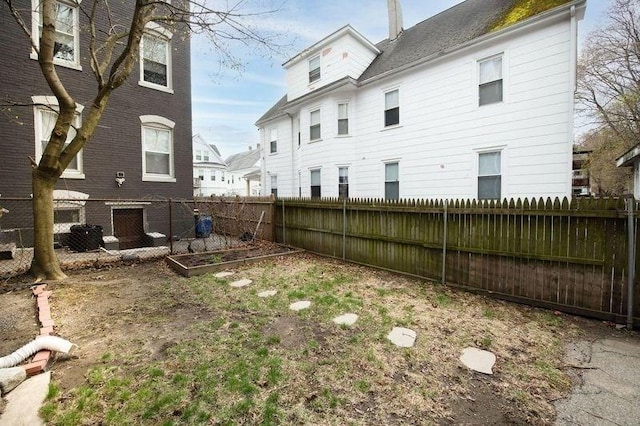 view of yard featuring a garden and a fenced backyard
