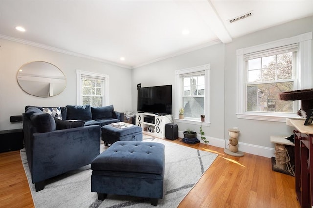 living room featuring baseboards, visible vents, a wealth of natural light, and wood finished floors