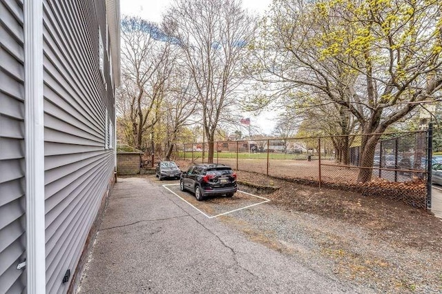 view of parking / parking lot with fence