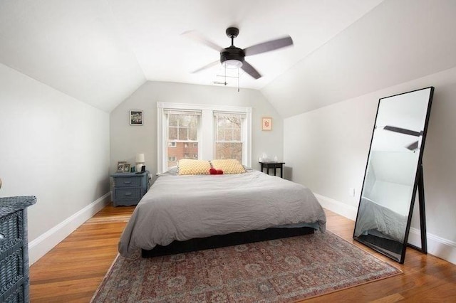 bedroom featuring baseboards, ceiling fan, light wood finished floors, and lofted ceiling