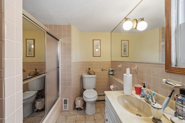 full bathroom with tile patterned flooring, tile walls, toilet, and visible vents