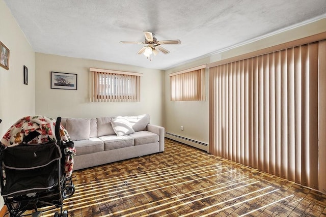 living area featuring a baseboard radiator, a textured ceiling, and ceiling fan