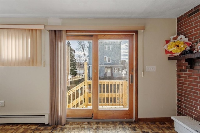 doorway to outside featuring brick wall, a baseboard heating unit, and baseboards