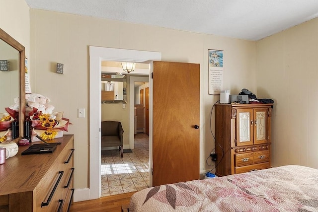 bedroom with light wood-type flooring and a baseboard radiator