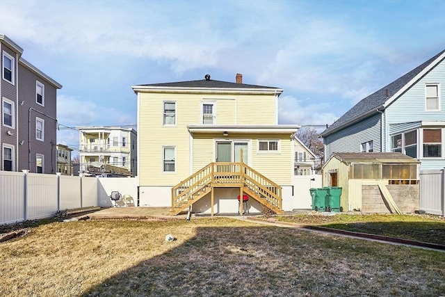 rear view of house with stairway, a patio, a fenced backyard, and a chimney