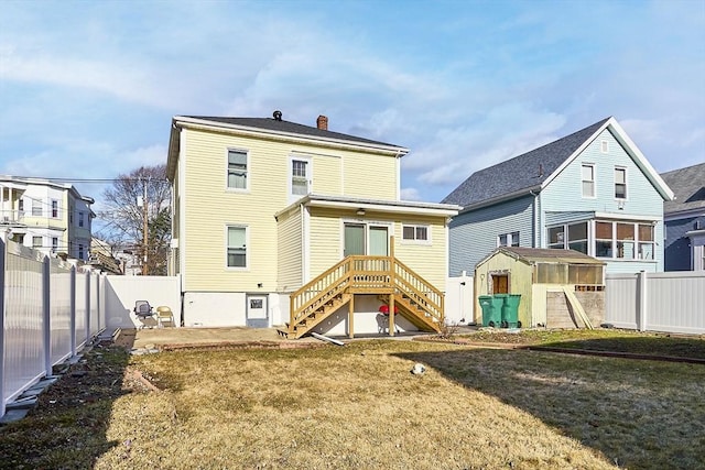 back of property featuring a shed, a fenced backyard, a chimney, an outdoor structure, and a patio area