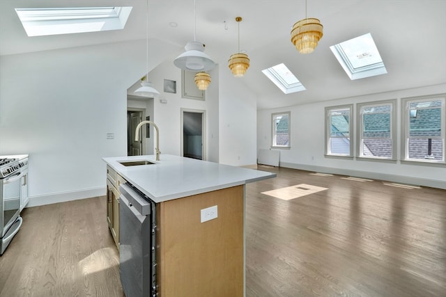 kitchen featuring light hardwood / wood-style flooring, vaulted ceiling, a center island with sink, and hanging light fixtures