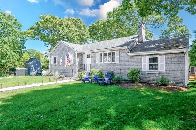 8 Highland View Ave, Mattapoisett, MA 02739 - view of front of house with a front yard, a chimney, and roof with shingles