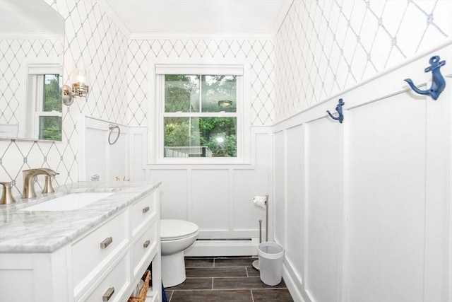 8 Highland View Ave, Mattapoisett, MA 02739 - bathroom with baseboard heating, a decorative wall, vanity, crown molding, and wood finished floors