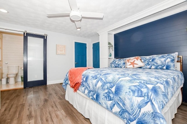 8 Highland View Ave, Mattapoisett, MA 02739 - bedroom with a barn door, wood finished floors, ensuite bathroom, ceiling fan, and recessed lighting