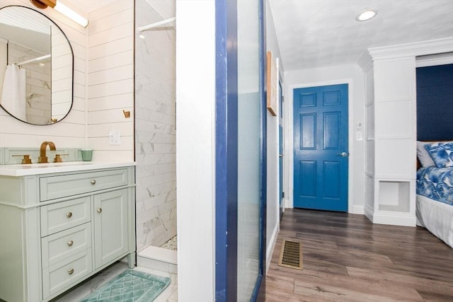 8 Highland View Ave, Mattapoisett, MA 02739 - bathroom featuring vanity, a tile shower, wood finished floors, and recessed lighting