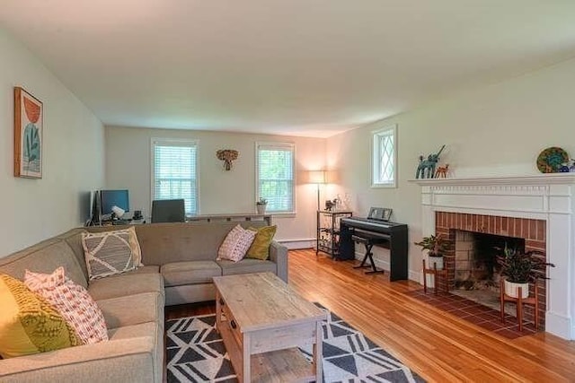 54 Warren St, Westborough, MA 01581 - living area featuring healthy amount of natural light, wood finished floors, and a fireplace