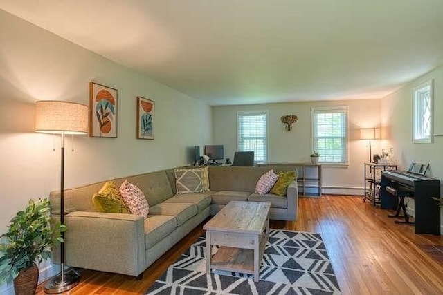 54 Warren St, Westborough, MA 01581 - living area with plenty of natural light, wood finished floors, and a baseboard radiator