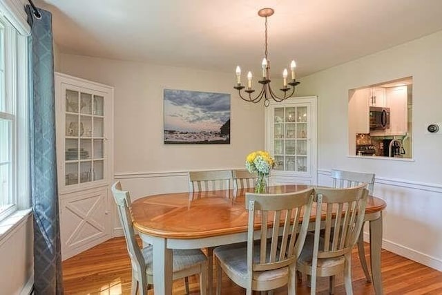 54 Warren St, Westborough, MA 01581 - dining area with light wood-style flooring, a chandelier, and a baseboard radiator