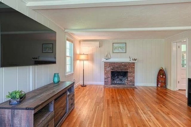 54 Warren St, Westborough, MA 01581 - living room featuring light wood-style floors, a brick fireplace, a decorative wall, and ornamental molding