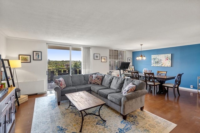 living room featuring a chandelier, crown molding, and dark hardwood / wood-style flooring