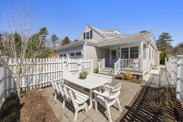 16 Walking Stick, Plymouth, MA 02360 - back of property with a fenced backyard, a garage, covered porch, and a patio