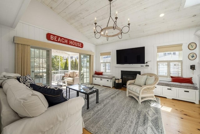 16 Walking Stick, Plymouth, MA 02360 - living area featuring light wood-style floors, plenty of natural light, a chandelier, a glass covered fireplace, and lofted ceiling