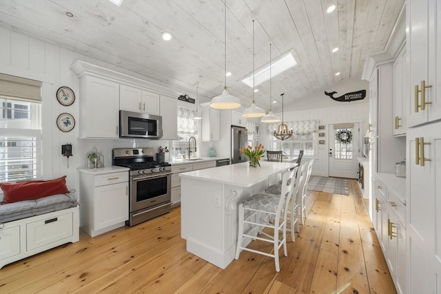 16 Walking Stick, Plymouth, MA 02360 - kitchen with appliances with stainless steel finishes, a center island, wooden ceiling, light countertops, and light wood-type flooring