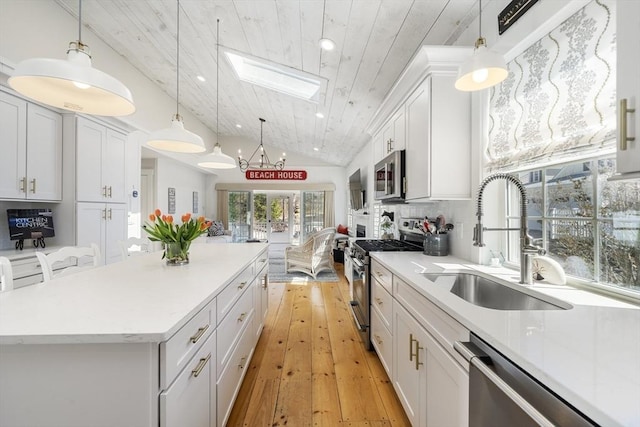 16 Walking Stick, Plymouth, MA 02360 - kitchen featuring appliances with stainless steel finishes, a skylight, wooden ceiling, white cabinetry, and a kitchen island