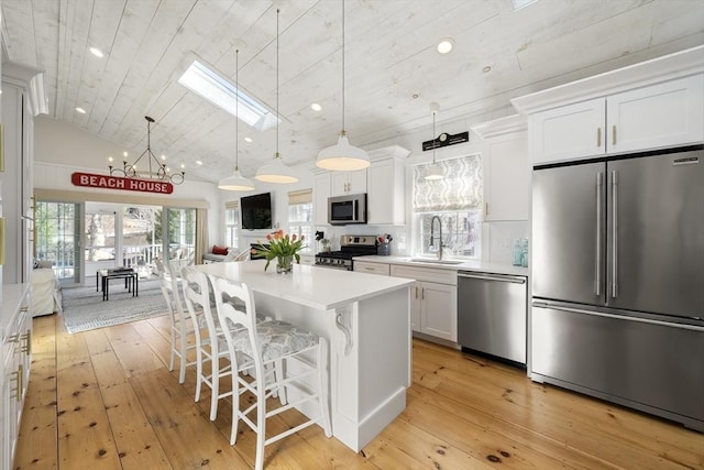 16 Walking Stick, Plymouth, MA 02360 - kitchen featuring stainless steel appliances, light wood-type flooring, white cabinets, a skylight, and light countertops