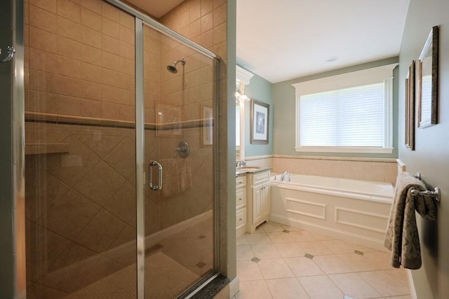 bathroom featuring vanity, a bath, tile patterned floors, and a stall shower