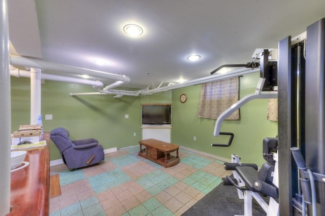 workout area featuring recessed lighting and baseboards