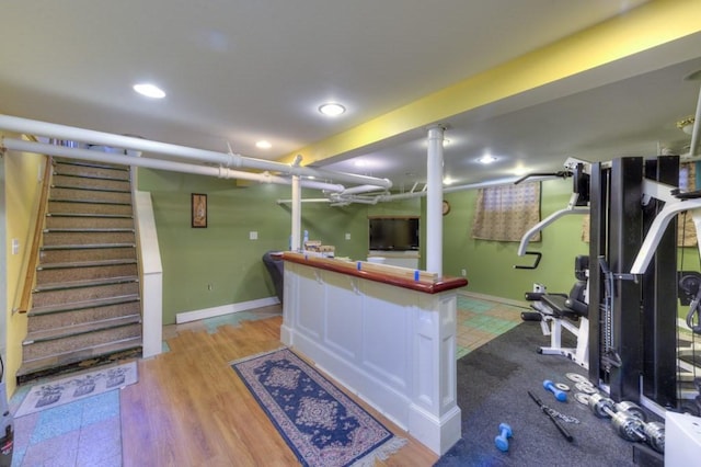 finished below grade area featuring recessed lighting, baseboards, and stairs