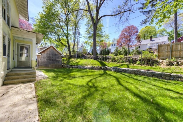 view of yard featuring fence and a residential view