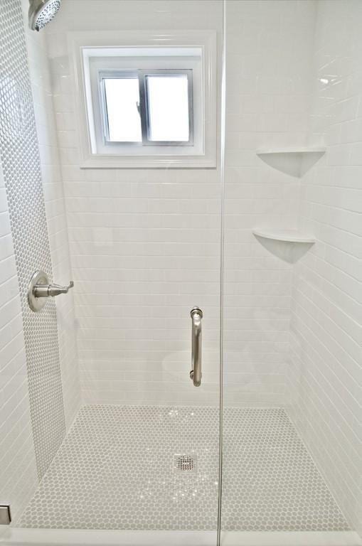 bathroom with a shower with door