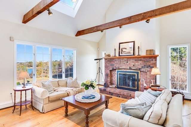 6 Snow Way, Orleans, MA 02653 - living area with high vaulted ceiling, a skylight, a fireplace, light wood finished floors, and baseboards