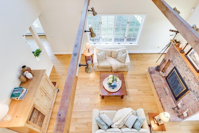 6 Snow Way, Orleans, MA 02653 - living area featuring wood finished floors, a fireplace, baseboards, and a baseboard heating unit