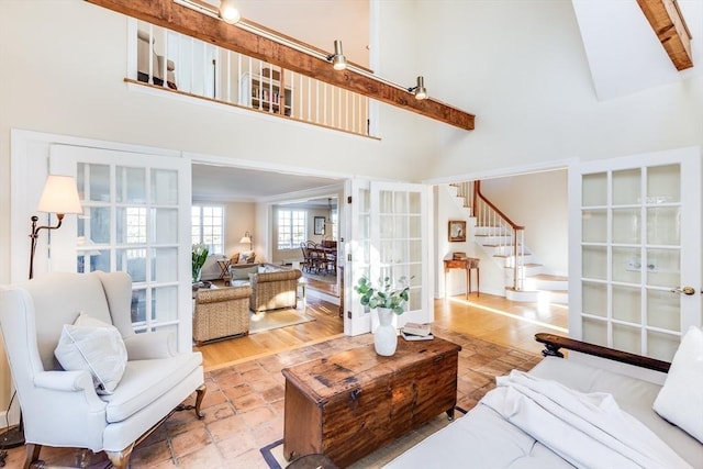 6 Snow Way, Orleans, MA 02653 - living area with high vaulted ceiling, french doors, stairs, and beam ceiling