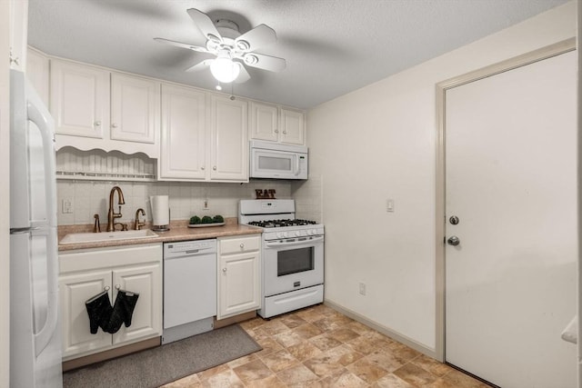 kitchen featuring sink, white cabinets, decorative backsplash, ceiling fan, and white appliances