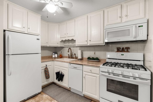 kitchen featuring sink, white appliances, white cabinets, and ceiling fan