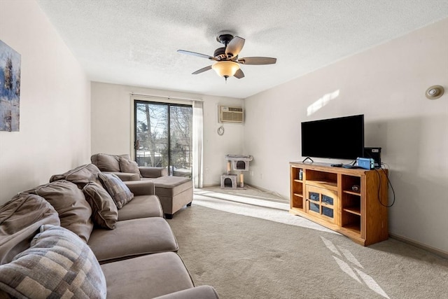 living room featuring ceiling fan, light carpet, a textured ceiling, and a wall unit AC