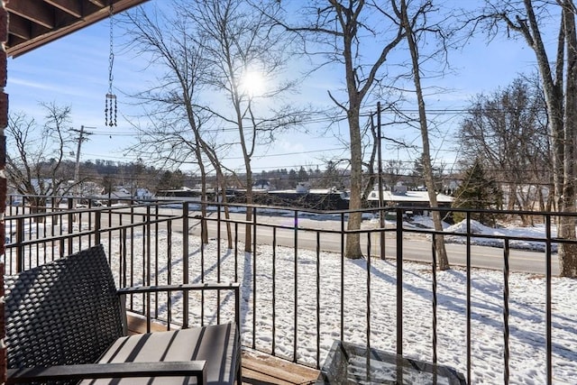 view of snow covered back of property