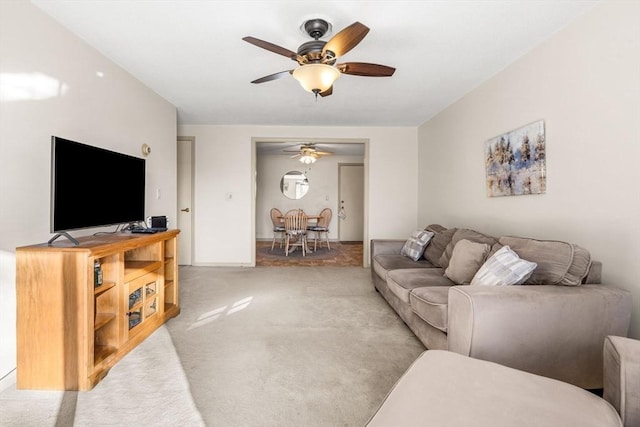 living room with ceiling fan and carpet