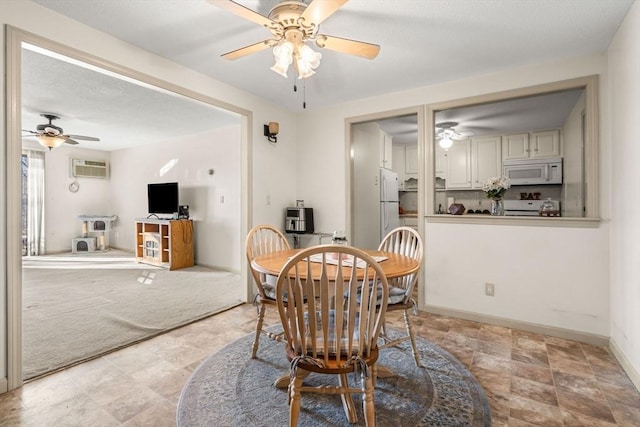 carpeted dining room featuring a wall mounted AC and ceiling fan