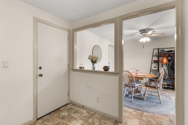 entrance foyer featuring ceiling fan