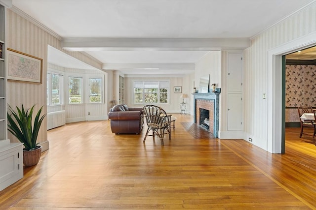 116 Adin St, Hopedale, MA 01747 - living area with wallpapered walls, radiator, light wood-type flooring, crown molding, and a fireplace