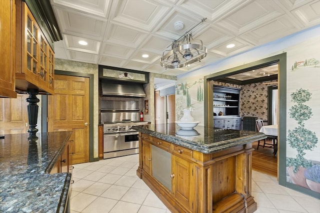 116 Adin St, Hopedale, MA 01747 - kitchen featuring range with two ovens, exhaust hood, brown cabinetry, light tile patterned floors, and glass insert cabinets
