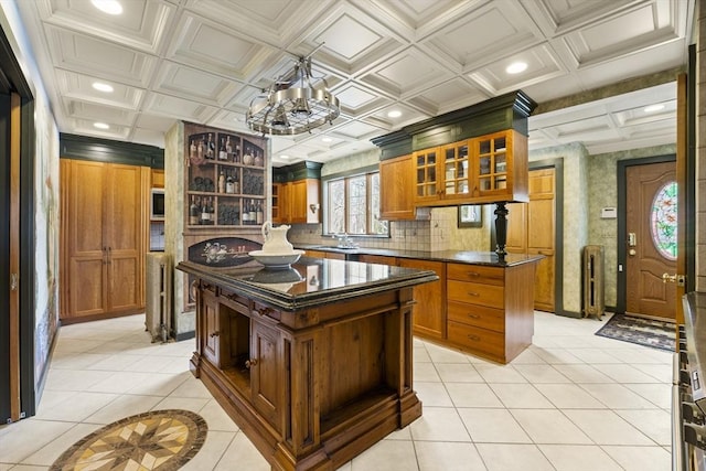 116 Adin St, Hopedale, MA 01747 - kitchen with light tile patterned flooring, brown cabinetry, glass insert cabinets, a peninsula, and recessed lighting