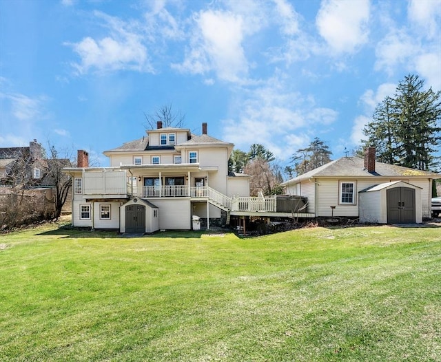 116 Adin St, Hopedale, MA 01747 - back of property with a storage unit, an outdoor structure, a deck, and a yard