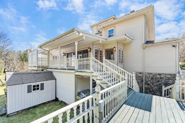 116 Adin St, Hopedale, MA 01747 - rear view of property featuring a storage unit, an outdoor structure, stairs, and a deck