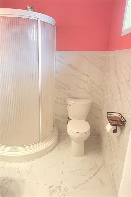 45 4th St, Worcester, MA 01602 - bathroom featuring marble finish floors, a shower stall, wainscoting, and tile walls